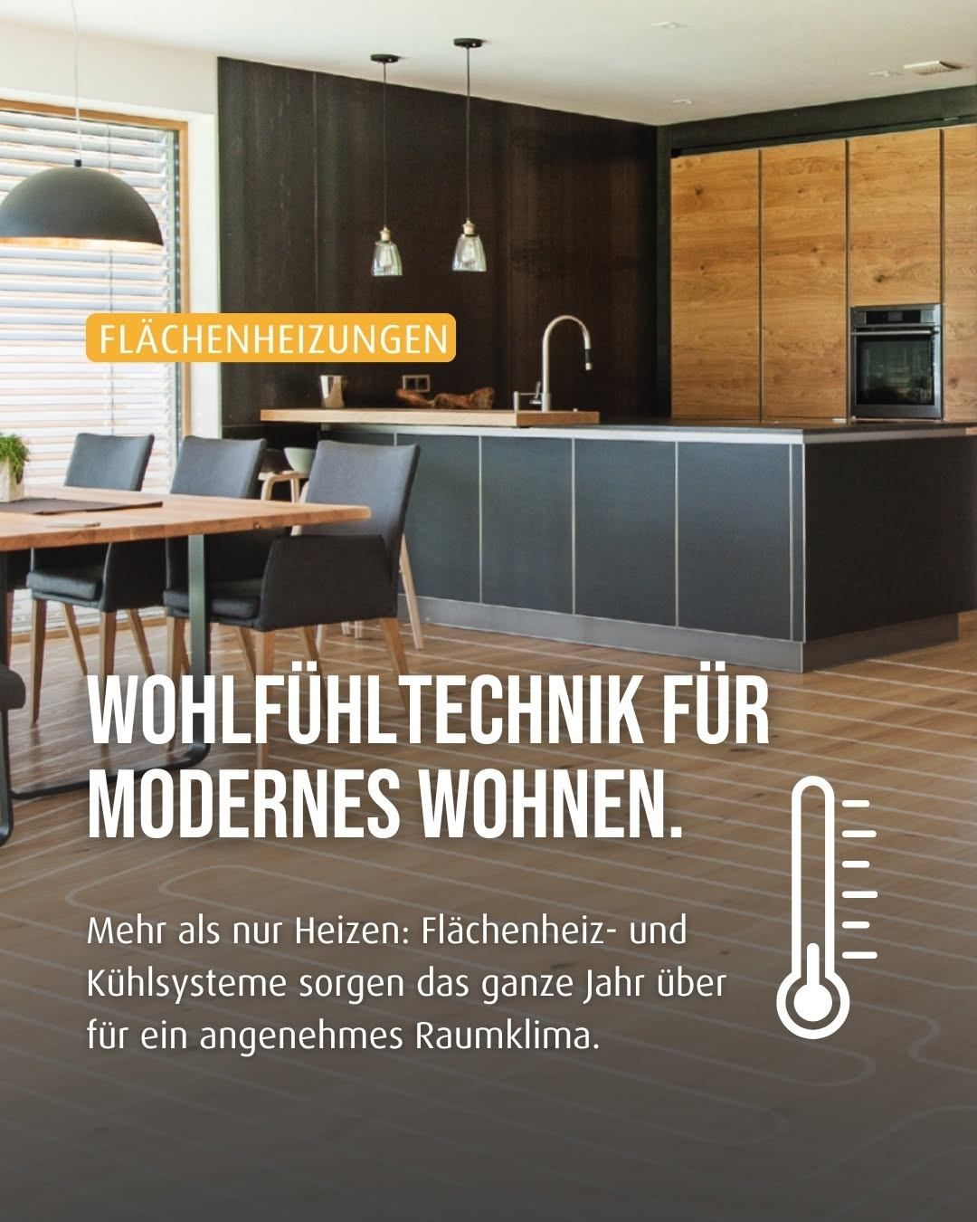 A modern kitchen with wooden floors, black cabinets, and a central island. A lamp hangs above the dining table. The image highlights floor heating technology for year-round comfort.