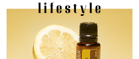 A lemon half with a bottle of doTERRA Lemon essential oil on a beige background. The words Stefanie Kohl and lifestyle are above.