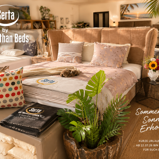 Serta by Than Beds Werbung mit einer Schlafzimmerszene mit einem Bett, Kissen und einer Katze, mit einer Pflanze in einem hölzernen Übertopf und einem kleinen Tisch mit einer Blumenvase.