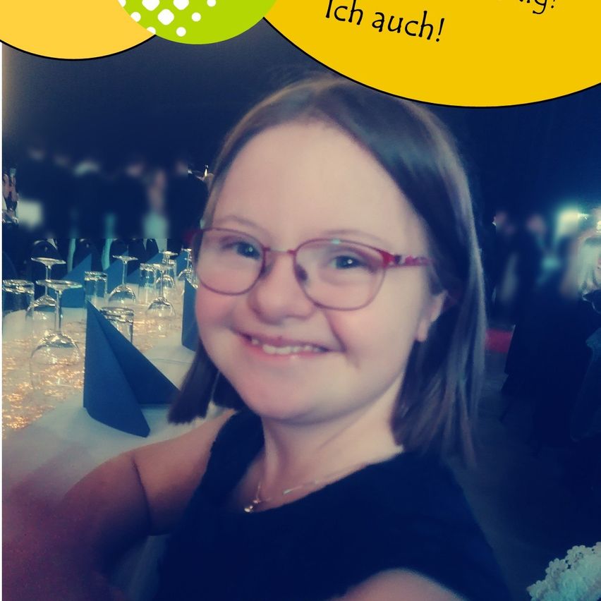 Ein lächelndes Mädchen mit Brille auf einer Dinnerparty, mit dem Text 'Ich auch!' über seinem Kopf und Weingläsern im Hintergrund.