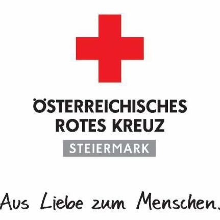 Das Emblem des Österreichischen Roten Kreuzes mit einem roten Kreuz und deutschem Text. Der Text übersetzt 'Aus Liebe zum Menschen'.