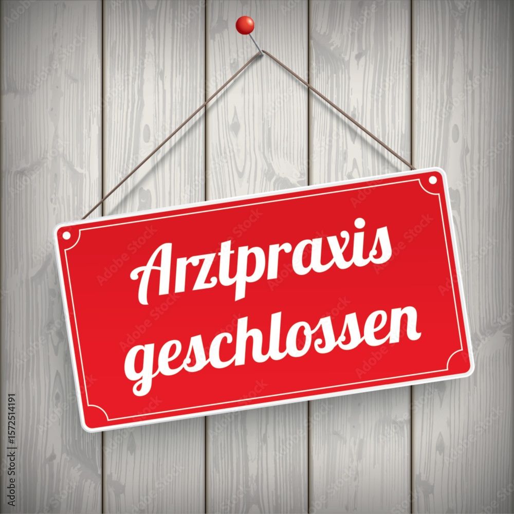 Ein rotes Schild mit weißem Text 'Arztpraxis geschlossen' hängt an einer Holzwand. Das Schild ist mit einer roten Nadel befestigt.