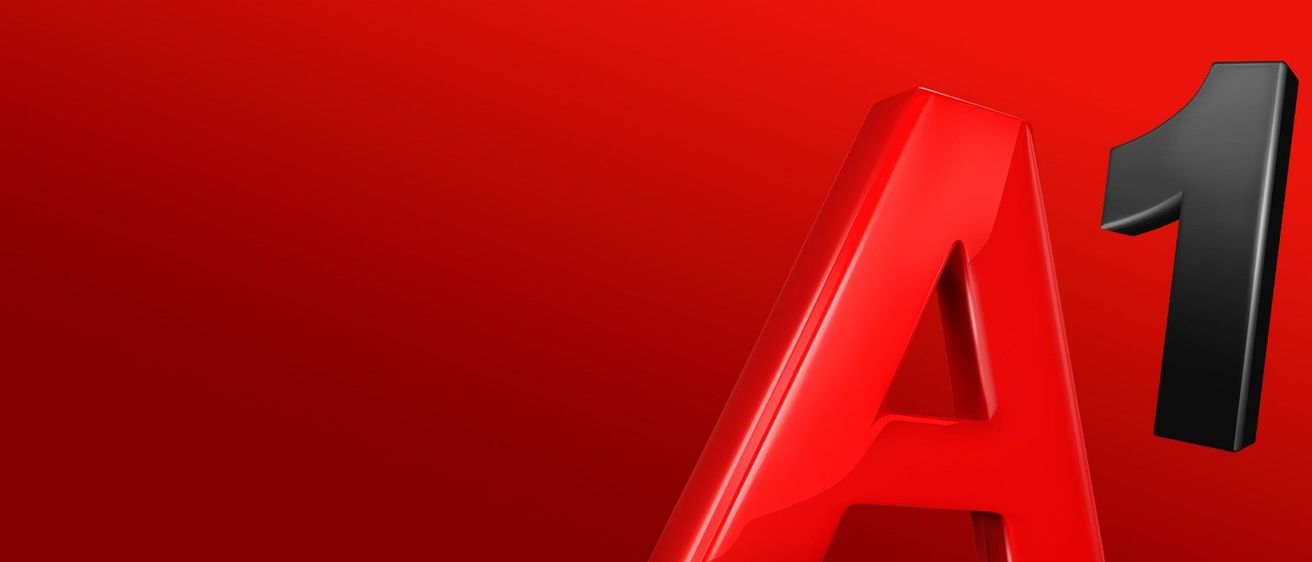 Ein glänzender roter Buchstabe 'A' auf rotem Hintergrund. Der Buchstabe ist leicht gebogen und hat eine glatte, reflektierende Oberfläche.