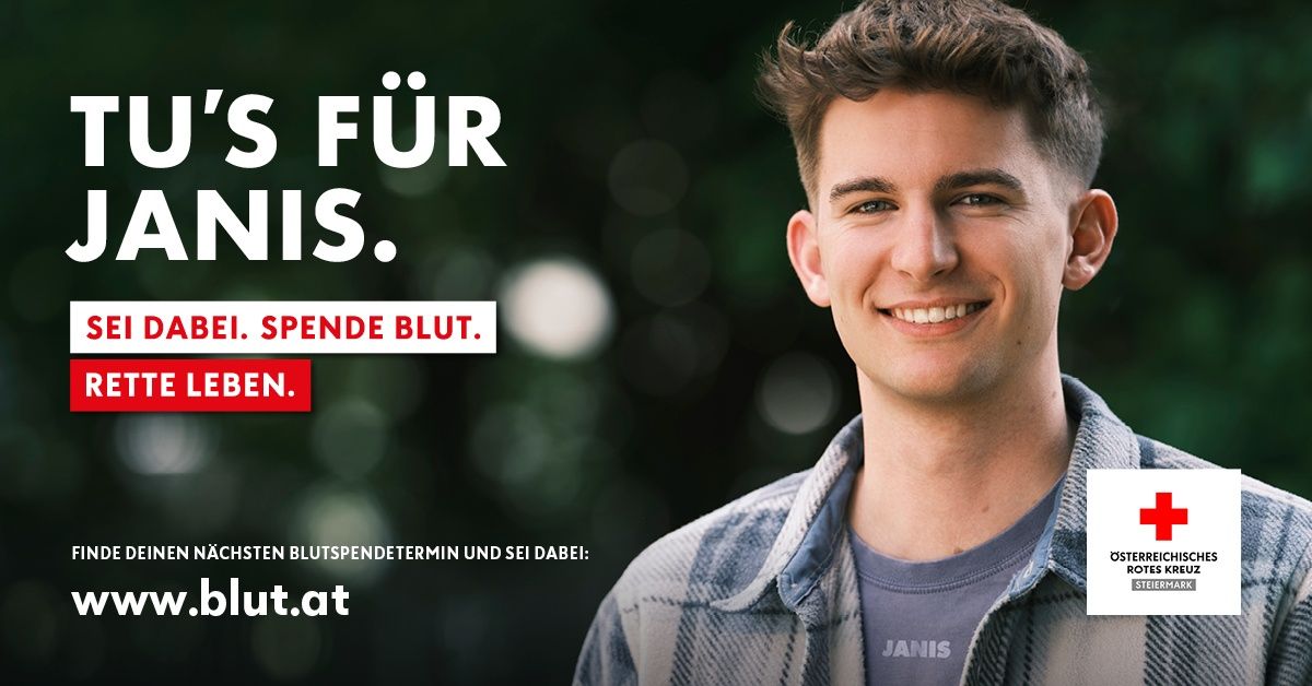 Ein lächelnder junger Mann mit einer Botschaft über Blutspenden. Der Text lautet 'S für Nis. Spende Blut. EN.' Er trägt ein kariertes Hemd und ein graues T-Shirt.