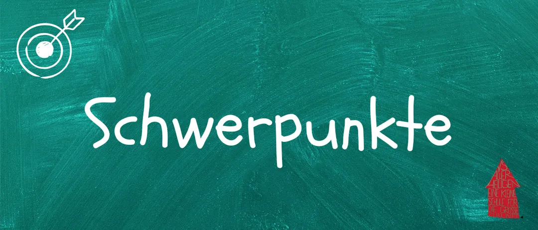 Das Wort 'schwerpunkt' ist in weiß auf einem grünen Tafelhintergrund geschrieben. Die Buchstaben sind groß und fett, was die Betonung des Begriffs nahelegt.