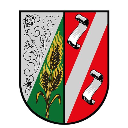 Das Bild zeigt einen heraldischen Schild mit einem grünen Feld und einem Weizengarben in der Mitte, flankiert von zwei Schriftrollen auf rotem und weißem Hintergrund. Der Schild hat einen schwarzen Rand.