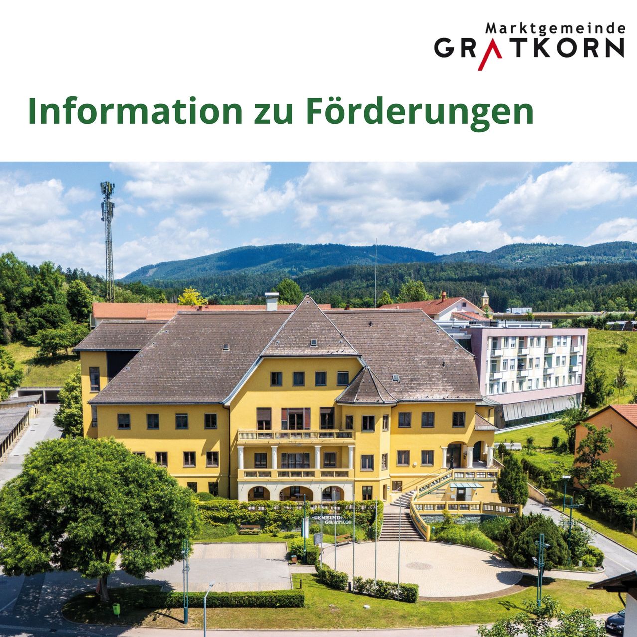An aerial view of a yellow building with a brown roof, surrounded by greenery and mountains in the background. The text 'Information zu Förderungen' is displayed at the top.