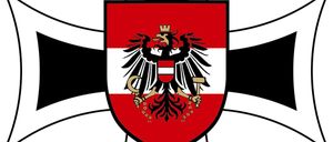 Ein heraldischer Schild mit schwarzem Rand enthält einen zweiköpfigen Adler, der einen Hammer und einen Blitz hält. Der Adler ist rot und weiß mit einer goldenen Krone.