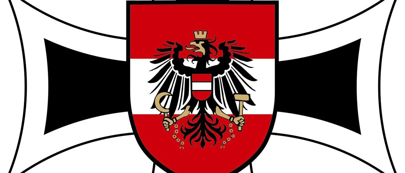 Ein heraldischer Schild mit schwarzem Rand enthält einen zweiköpfigen Adler, der einen Hammer und einen Blitz hält. Der Adler ist rot und weiß mit einer goldenen Krone.