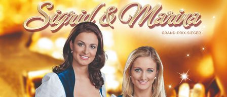 Plakat für ein Konzert mit zwei Frauen, Sigurd & Marina, die Gitarre spielen. Es steht Heimatgefuhle zur Weihnachtszeit. Datum: Sonntag, 21. Dezember 2025. Beginn: 19:30 Uhr. Kartenvorverkauf mit Platzreservierung. Preis: 25,00 Euro.