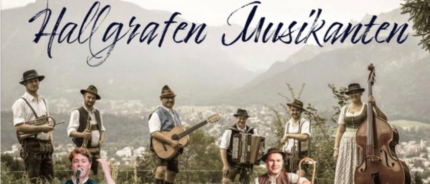 A group of musicians playing various instruments are standing in a field with mountains in the background. The text reads '30. December 2025 19 Uhr Einlass 20 Uhr Beginn Gasthaus Dichtlwiert.' Admission is 15 euros.