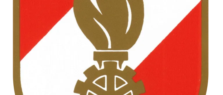 Das Emblem einer Flamme auf einem Zahnrad auf einem Schild mit rotem und weißem Hintergrund.