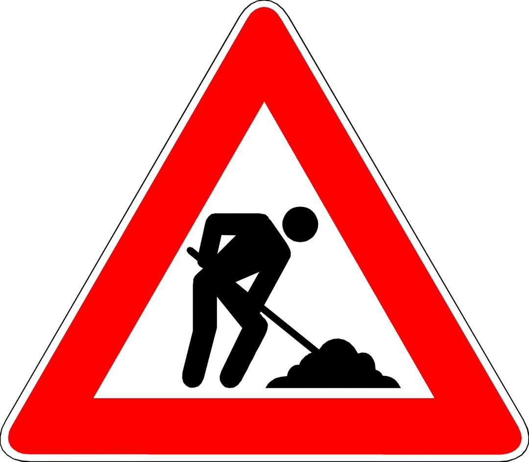 A triangular sign with a man holding a shovel digging dirt. It is likely a warning sign for roadwork.