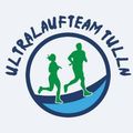Das Logo zeigt eine stilisierte Darstellung eines Mannes und einer Frau beim Laufen, eingeschlossen in einem blauen Kreis, mit dem Text Ultralaufteam Tulln prominent angezeigt.