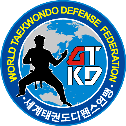 Ein kreisförmiges Logo mit einer Silhouette einer Person in einer Kampfsporthaltung, mit den Worten 'World Taekwondo Defense Federation' und 'ITF' in Koreanisch und Englisch. Das Logo enthält eine stilisierte Weltkugel im Hintergrund.