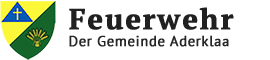 The image shows the logo for the Aderklaa community fire department. It features a shield with a cross and wheat symbol, set against a black background. The text reads 'Feuerwehr Der Gemeinde Aderklaa'.