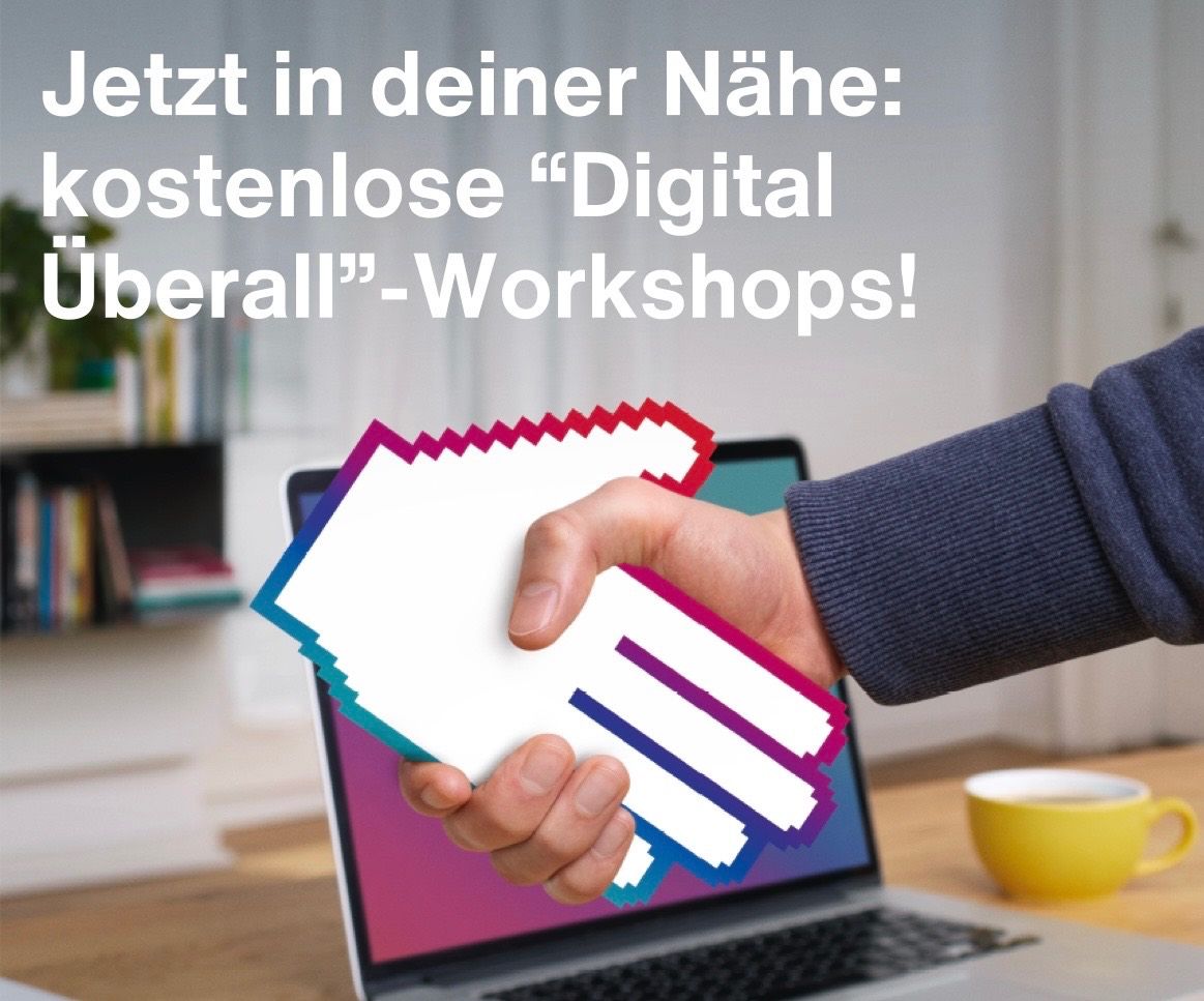 A hand holding a pixelated icon is over a laptop screen with text about free digital workshops. Behind the laptop is a bookshelf and a yellow mug.