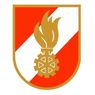 Ein Schild mit rotem und weißem Hintergrund, mit goldener Flamme und Zahnradsymbol.