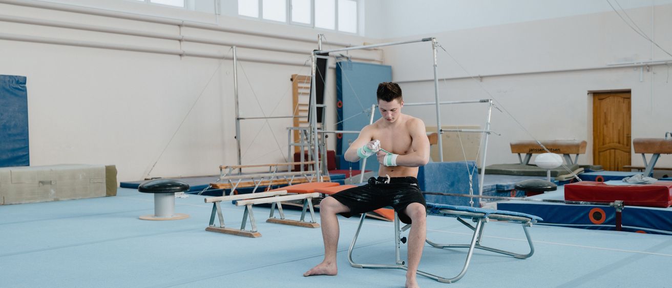 Bild enthält, Boy, Male, Person, Teen, Glove, Acrobatic, Gymnast, Gymnastics, Pilates, Chair