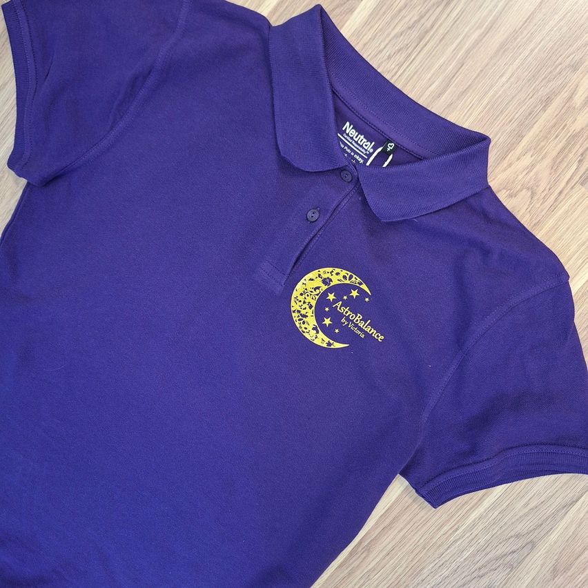 A purple polo shirt with a yellow moon and stars logo on the left chest area. The brand name 'Neutral' is printed on the collar.