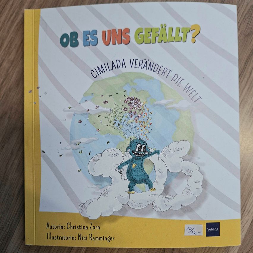 A book cover with a blue monster on a cloud, holding a heart, and surrounded by falling objects. The title reads 'Ob es uns gefällt?' and the subtitle reads 'Cimilada verändert die Welt.' The author is Christina Zorn and the illustrator is Nici Ramminger.