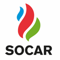 Das SOCAR-Logo zeigt eine stilisierte Flamme mit blauen, roten und grünen Farben auf weißem Hintergrund. Der Schriftzug 'SOCAR' steht in fetten schwarzen Buchstaben unter der Flamme.