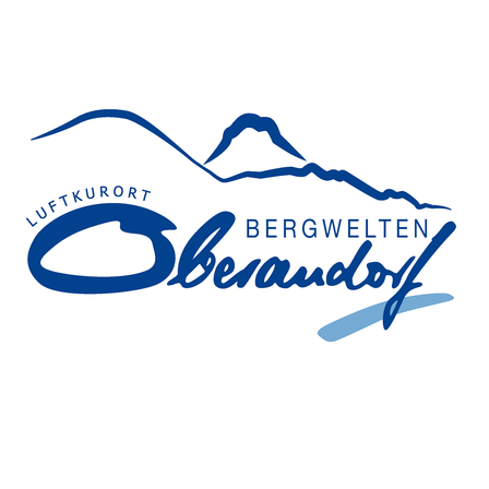 Das Logo für Bergwelten Oberndorf Luftkurort zeigt eine stilisierte Bergkette mit blauem Himmel und Berggipfeln.