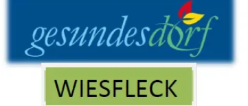 Ein blaues Logo mit weissem Text, der 'gesundesdorf' und ein rotes Blattsymbol zeigt. Darunter steht weisser Text 'WIESFLECK'.