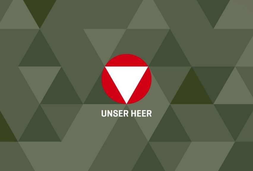 A red circle with a white triangle inside, overlaying a green geometric pattern. The text 'UNSER HEER' is written below the circle in white font.