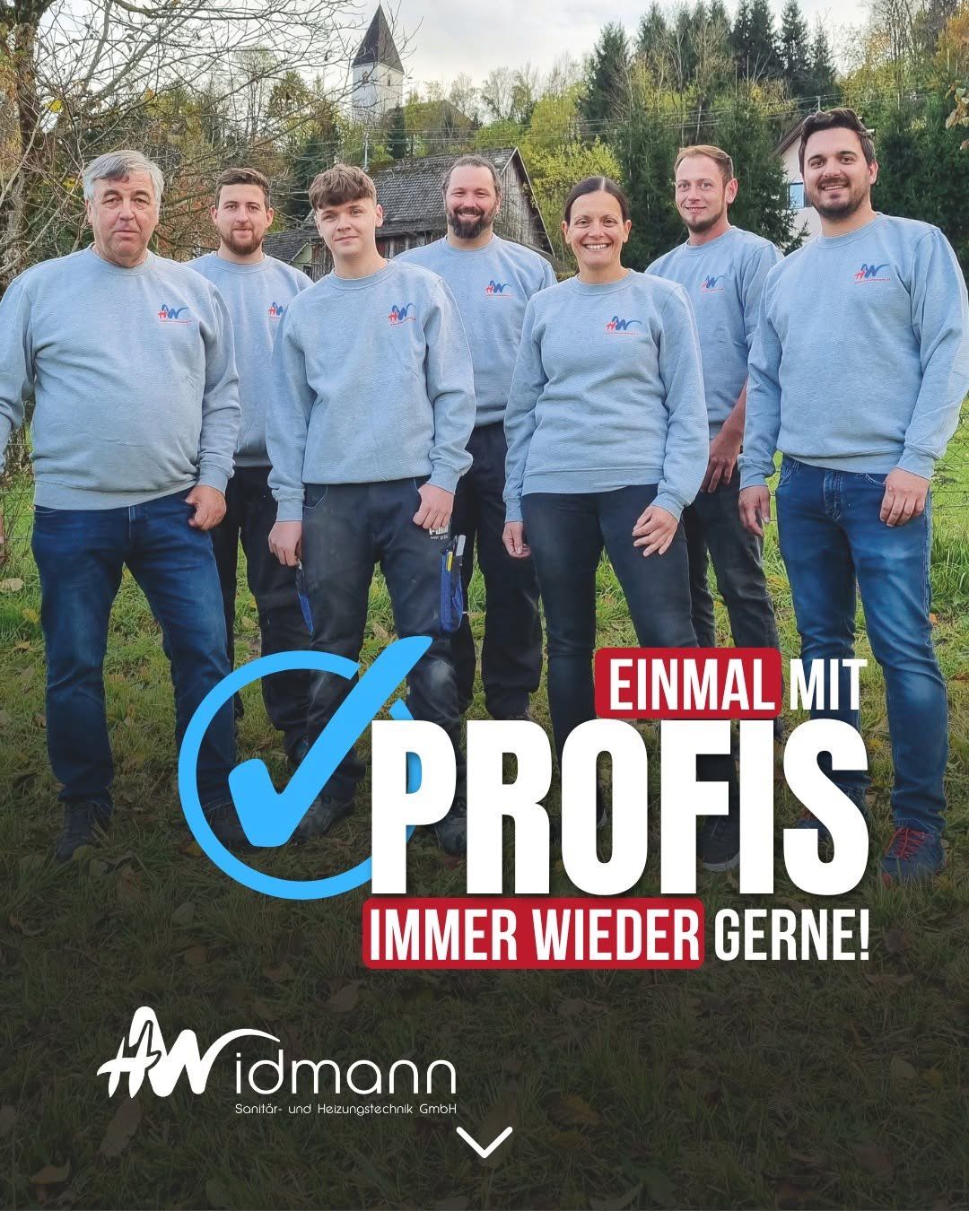 Eine Gruppe von sieben Personen, alle in passenden blauen Sweatshirts mit einem Logo, stehen auf einer Rasenfläche. Sie scheinen für ein Foto zu posieren. Der Text 'EINMAL MIT PROFIS IMMER WIEDER GERN!' ist prominent angezeigt.