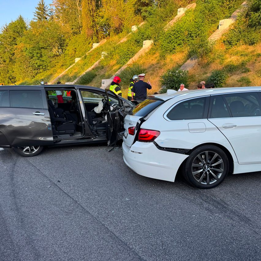 Zwei Autos sind auf einer Straße kollidiert, und Rettungskräfte sind am Unfallort.