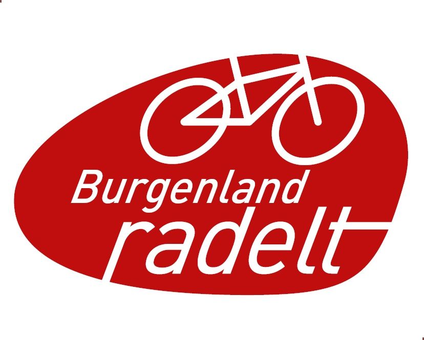 Das rote Logo zeigt ein weißes Fahrrad über dem Text 'Burgenland radelt'. Das Fahrrad ist in Bewegung dargestellt, was Radfahren suggeriert. Der Hintergrund ist oval und rot gefärbt.