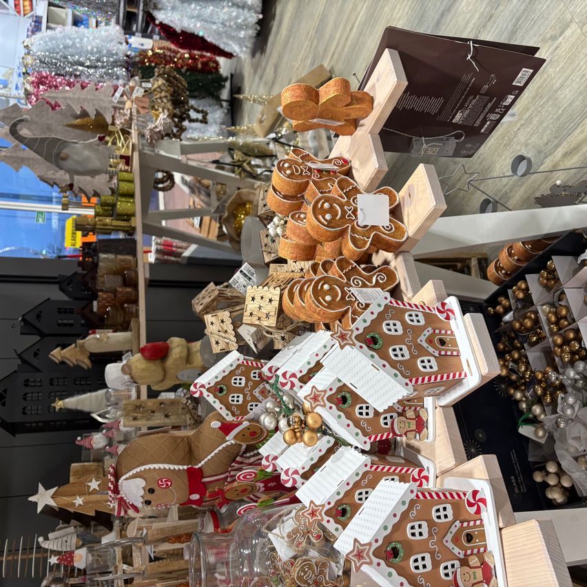 A store displays an array of gingerbread decorations, including gingerbread men, houses, and ornaments, all in festive holiday decor.