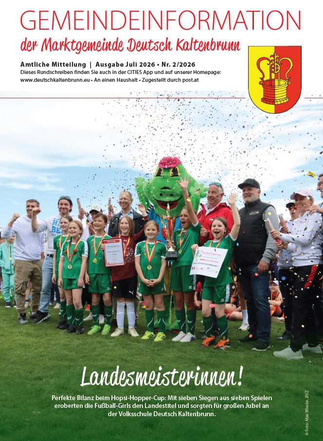 Official announcement from the municipality of Deutsch Kaltenbrunn. July 2026 issue. A group of children celebrates with a mascot, holding trophies and certificates. The event is related to a soccer cup. The children are wearing green uniforms and medals.