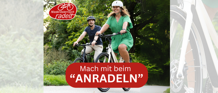 Eine Werbung für Niederösterreich radelt zeigt einen Mann und eine Frau, die im Freien Rad fahren. Die Frau trägt ein grünes Kleid, der Mann trägt Freizeitkleidung. Beide tragen Helme. Der Text lautet 'Mach mit beim ANRADELN.'
