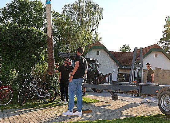 Men versammeln sich um einen LKW, der Fahrräder entlädt, an einem sonnigen Tag in einem Wohngebiet.