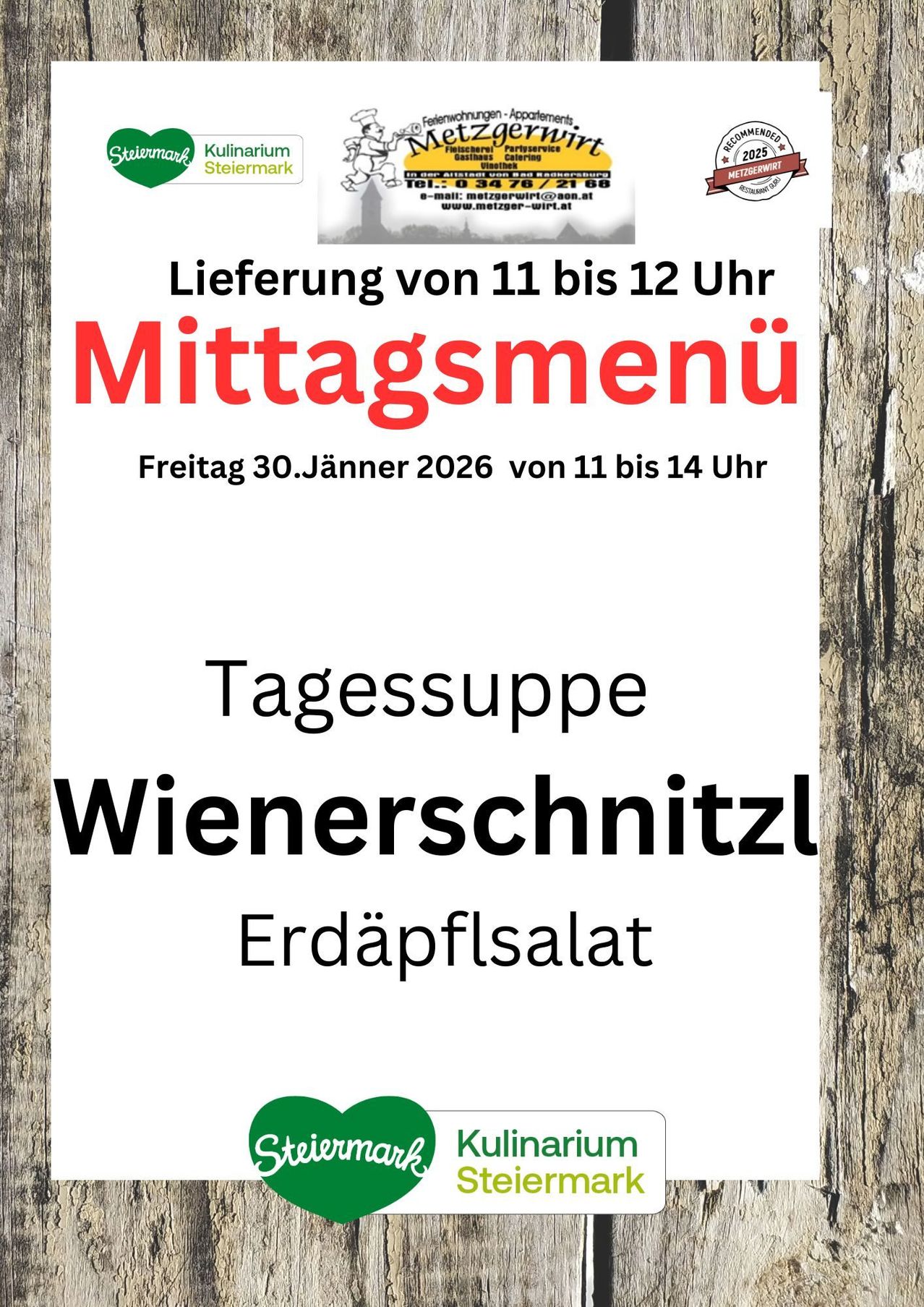 Ein Plakat bewirbt ein Mittagsmenü für Freitag, 30. Jänner 2026. Es enthält ein Wiener Schnitzel und Erdäpfelsalat, mit Lieferung von 11 bis 12 Uhr.