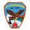 Freiwillige Feuerwehr Hirtenberg-Logo. Ein sechseckiges Emblem zeigt einen aufsteigenden Adler, der ein gelbes Objekt hält, über einer brennenden Flamme und einem ruhigen Gewässer. Der Text lautet 'FF Hirtenberg est. 1874'.