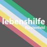 A rainbow-colored striped background with white text. The text reads 'lebenshilfe' in large letters and 'Furstenfeld' below it.