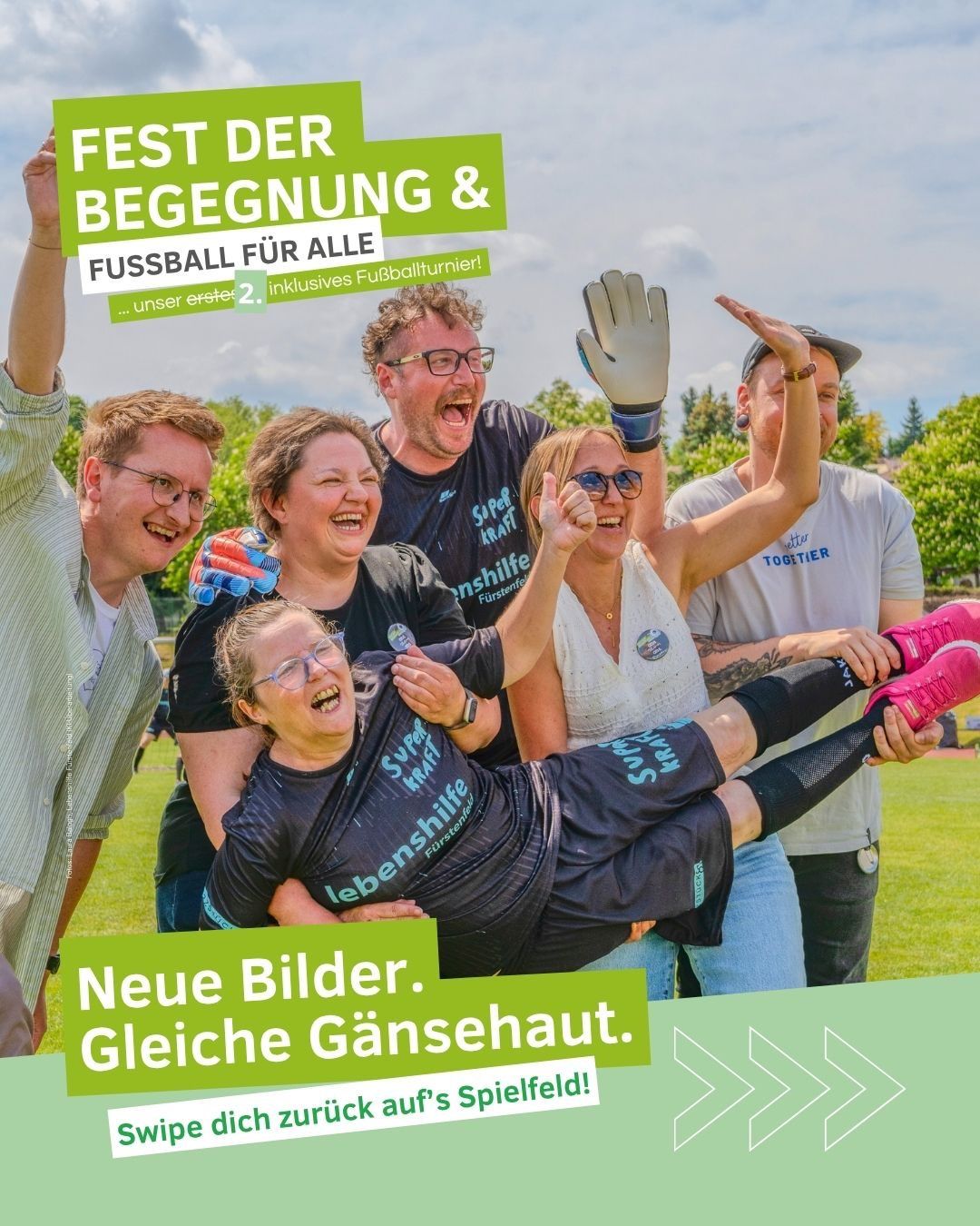 A group of people is standing on a field with text that reads 'Fest der Begegnung & Fussball fur alle.' They are all smiling and seem to be having a good time.
