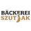 Das Logo der Bäckerei namens Backerei Szut Ak, mit einem lächelnden Gebäck und dem Markennamen in einer verspielten Schrift.