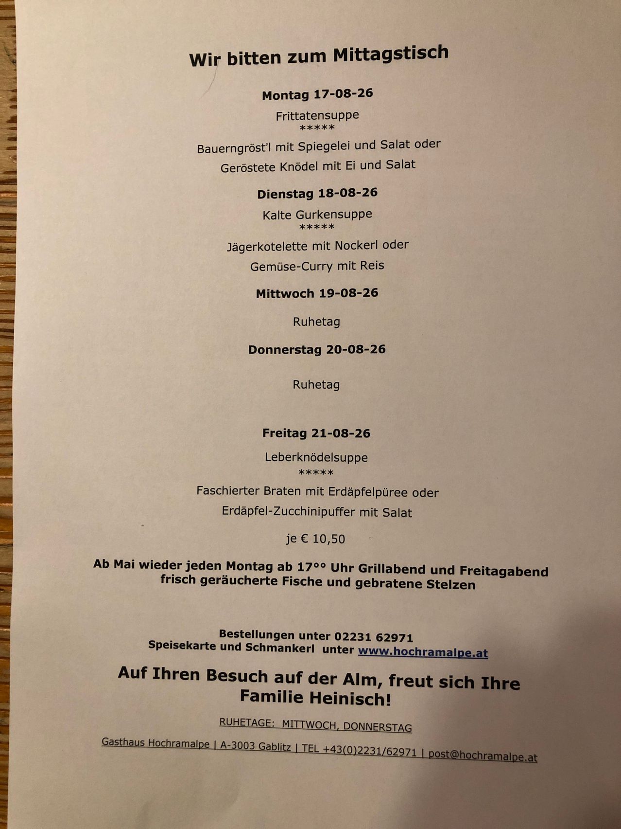 A menu with daily meal options from Monday to Friday, including soup, meat dishes, and prices. The menu is for a restaurant named Heinisch.