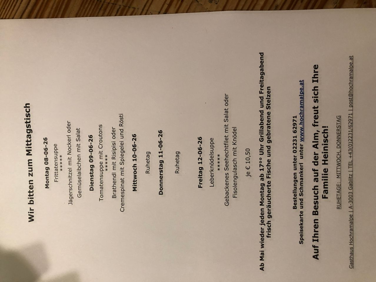 A document shows a menu for a restaurant, listing dishes and prices for various days. Dates and meal options are provided with a website link.