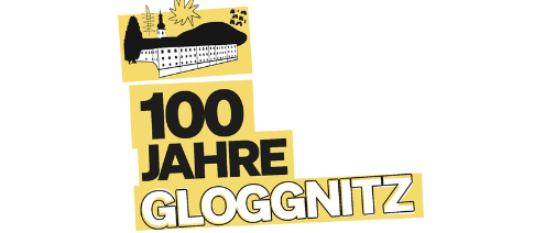 Ein goldenes Schild zur Feier von 100 Jahren Gloggnitz, mit einer Silhouette einer Burg auf einem Hügel und einem Sonnenaufgang im Hintergrund.