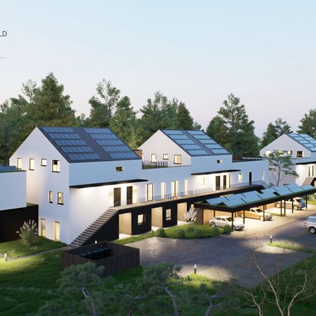 Eine Vogelperspektive auf moderne, mit Solarpanels ausgestattete Häuser in einer Vorstadtsiedlung.