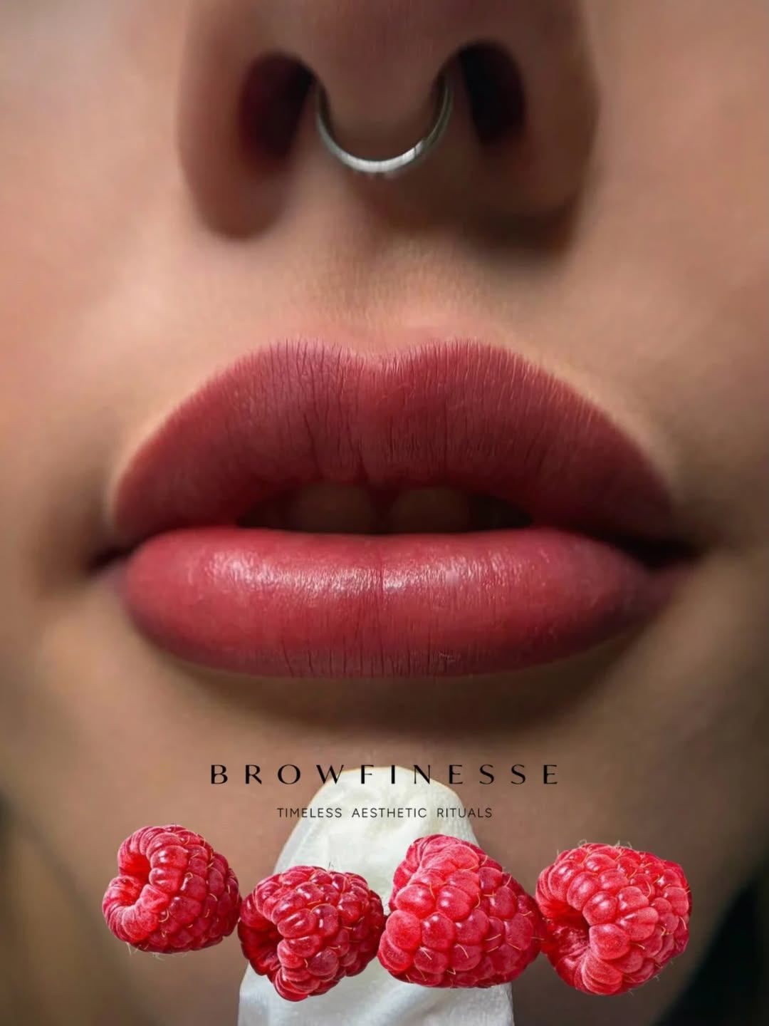 A close-up of a woman's lips with red lipstick, a nose ring, and a few raspberries in the foreground. The text 'BROWFINESS' and 'TIMELESS AESTHETIC RITUALS' is displayed.