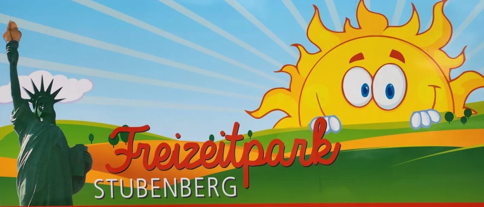 Eine fröhliche Sonne lächelt hell über eine Landschaft mit den Worten Freizeitpark Ubenberg auf einem blauen Himmelshintergrund.