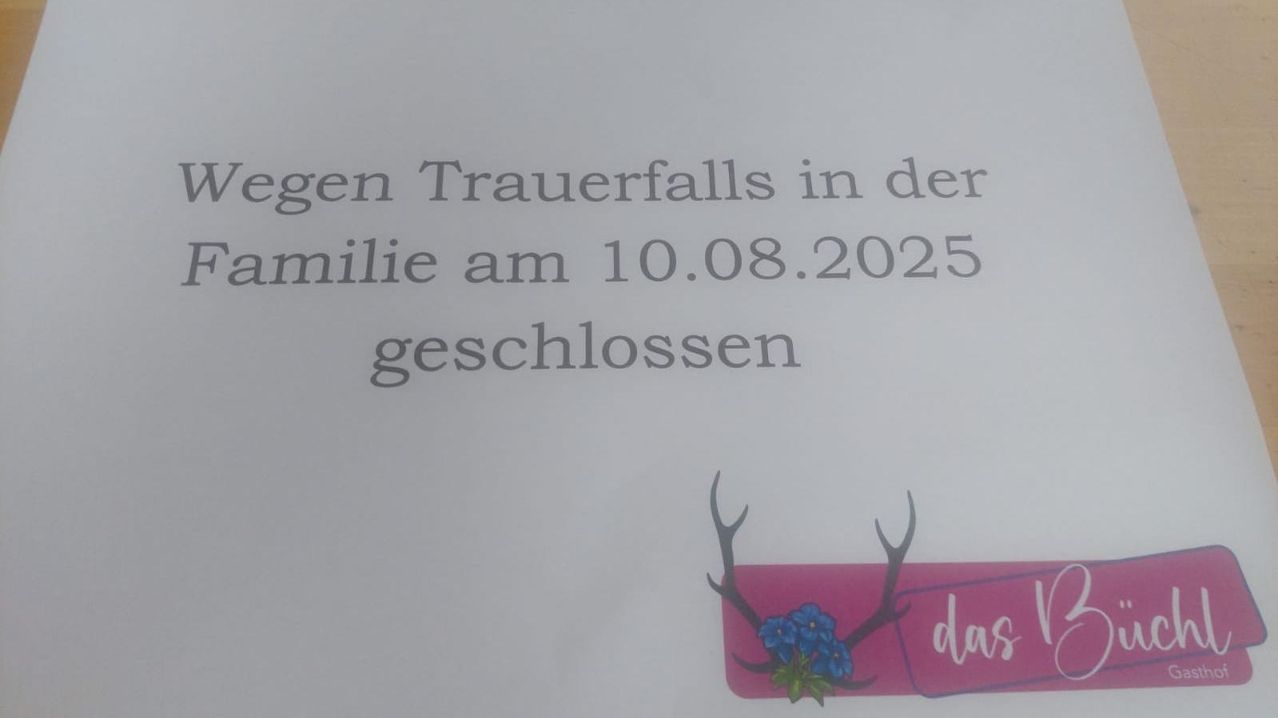 Ein Hinweis besagt 'Geschlossen wegen Trauerfall in der Familie am 10.08.2025' mit einem rosa Etikett und Geweih, geschmückt mit blauen Blumen.