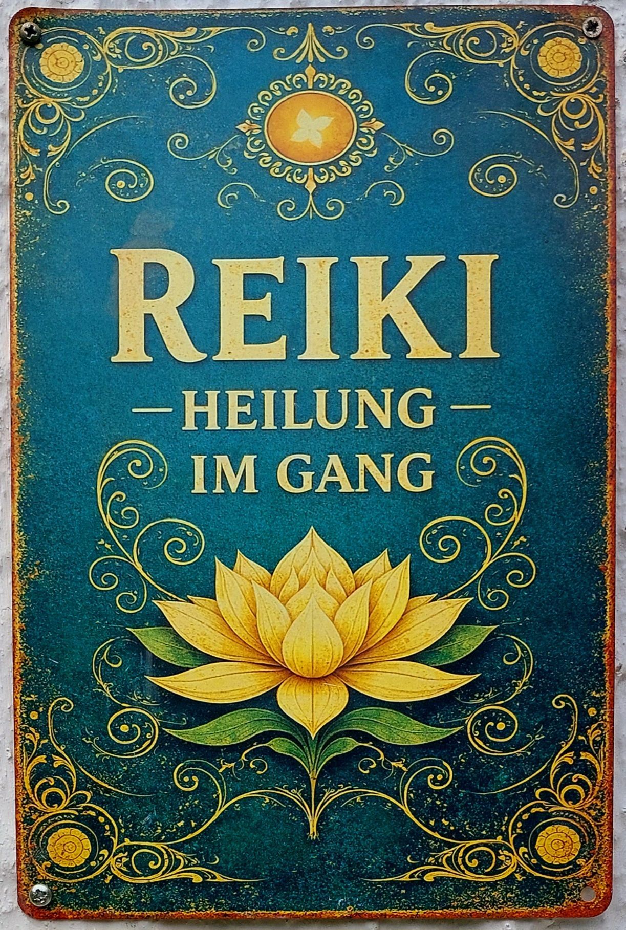 A poster with a blue background featuring the word Reiki in large golden letters, accompanied by a yellow lotus flower and decorative swirls.