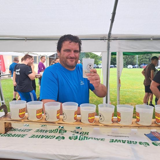Bild enthält, Person, Portrait, Dining Table, Table, Shelter, Grass, Adult, Male, Man, Text